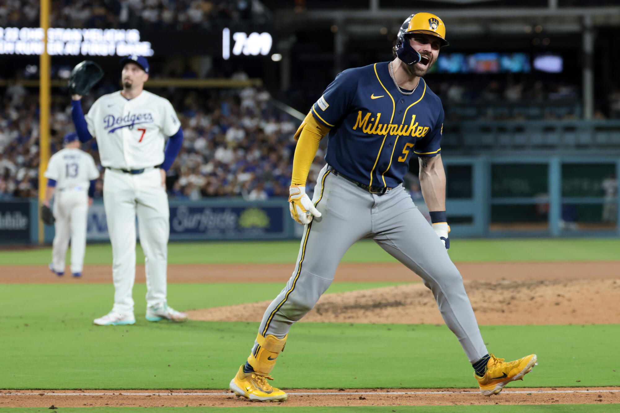 The Brewers' Garrett Mitchell yells after hitting a solo home run while pitcher Blake Snell watches.
