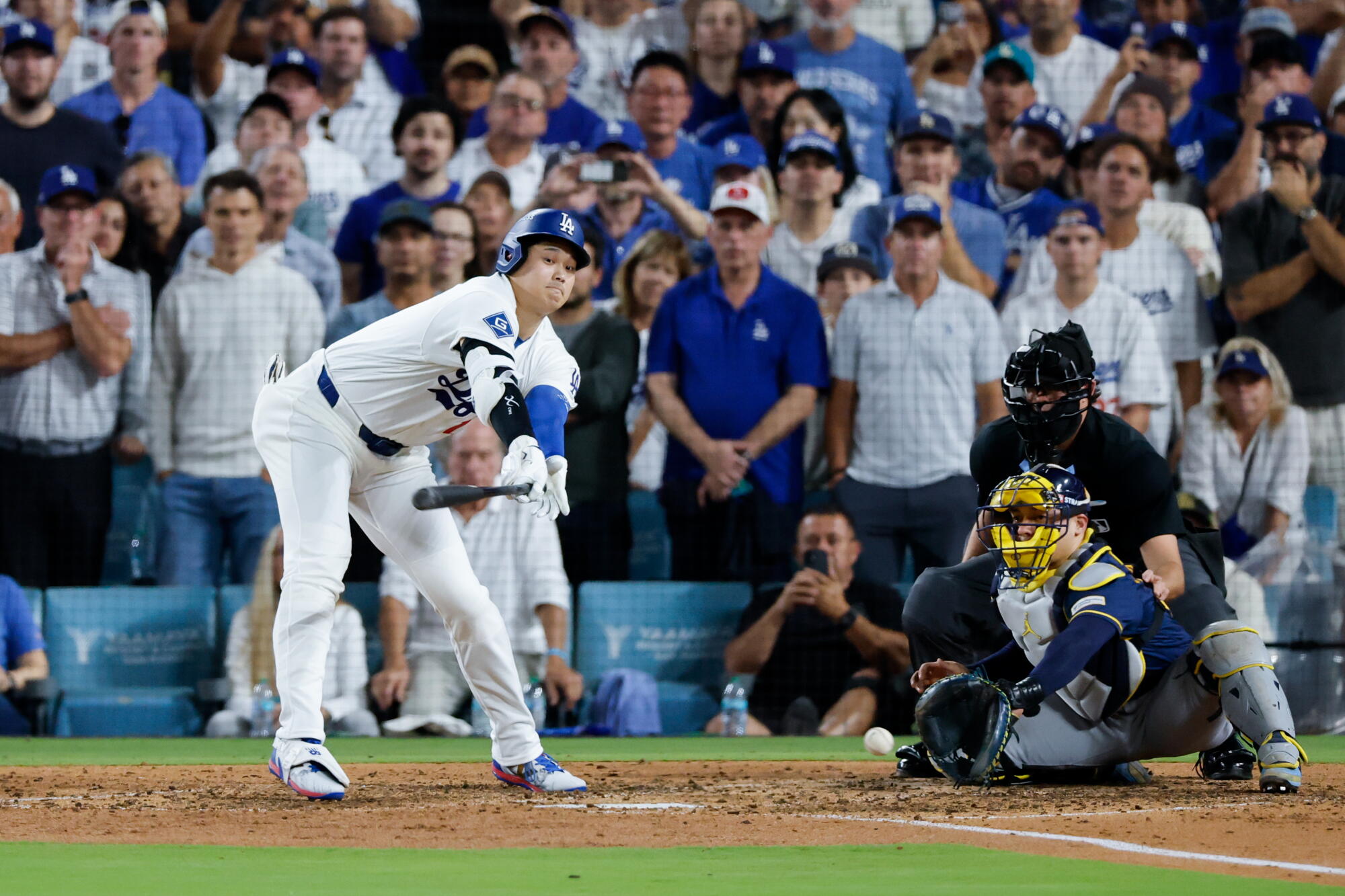 Dodgers star Shohei Ohtani strikes out with a runner on third during the seventh inning of Game 4 of the NLCS.
