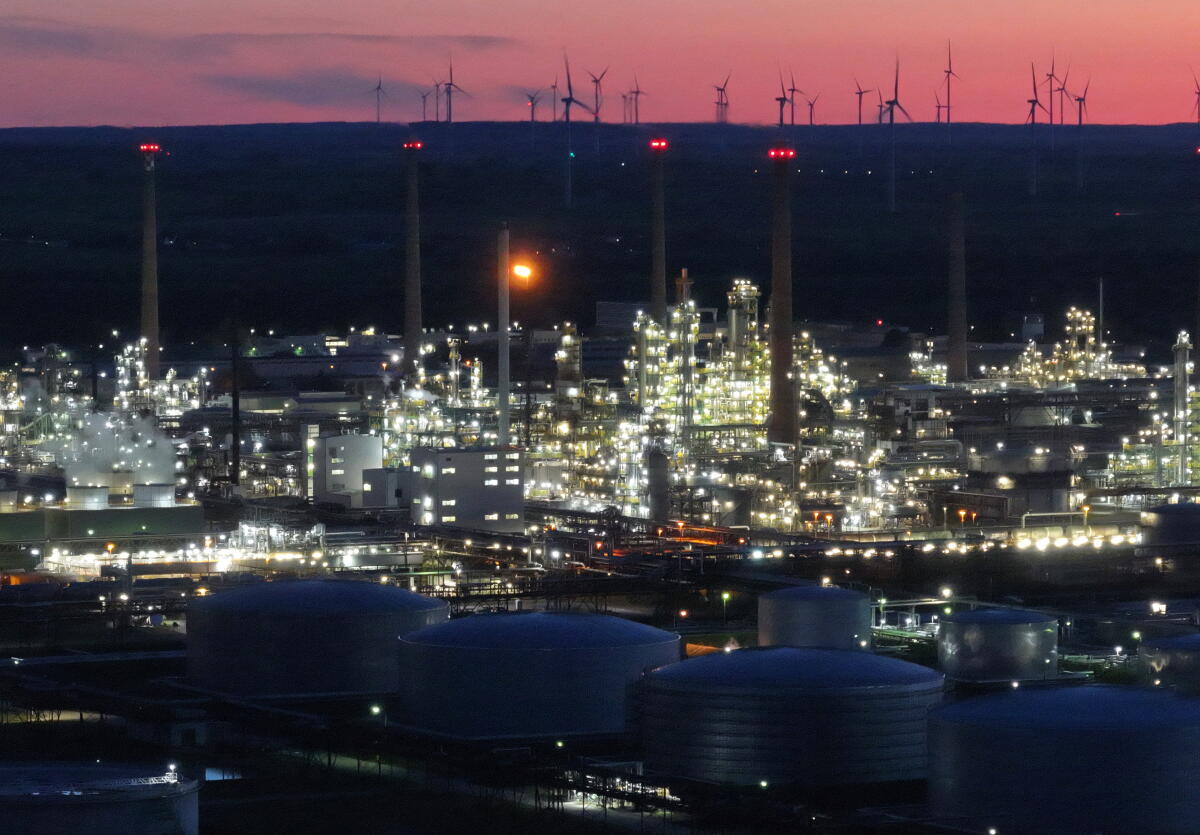 In this aerial view the PCK petroleum refinery stands illuminated at twilight