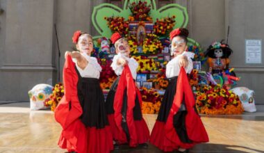three female dancers in traditional Mexican costume