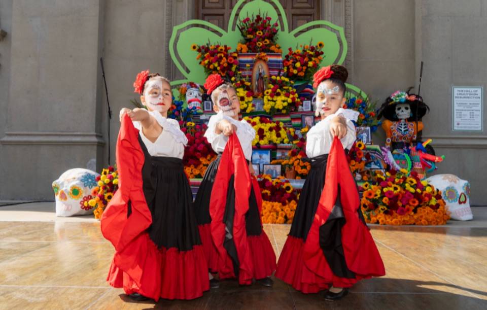 three female dancers in traditional Mexican costume