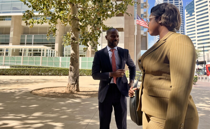 Haitian Bridge Alliance co-founder Wister Gaetan stands outside the United States Courthouse in downtown San Diego alongside a paralegal from Saint-Jeans Law Firm, Oct. 16, 2026.