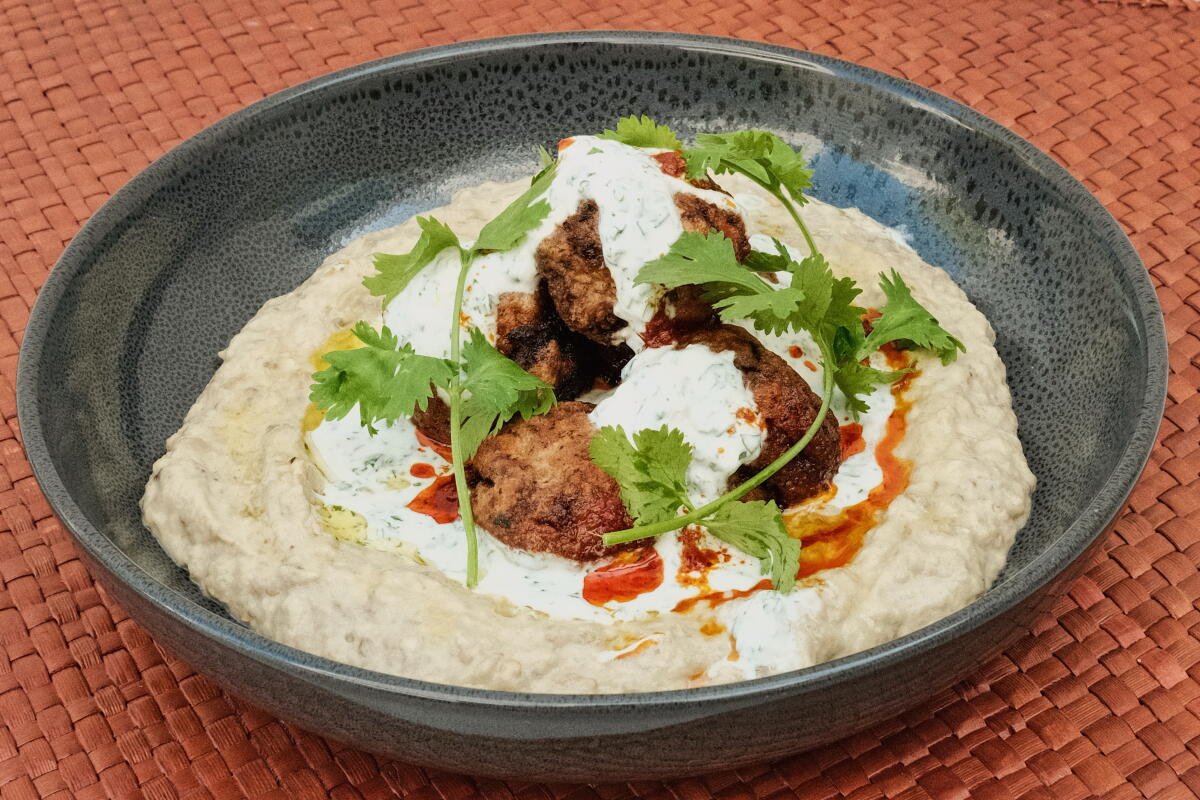 A bowl of meatball and herb-topped mutabbal prepared by Los Angeles Times Cooking editor Cody Reiss.