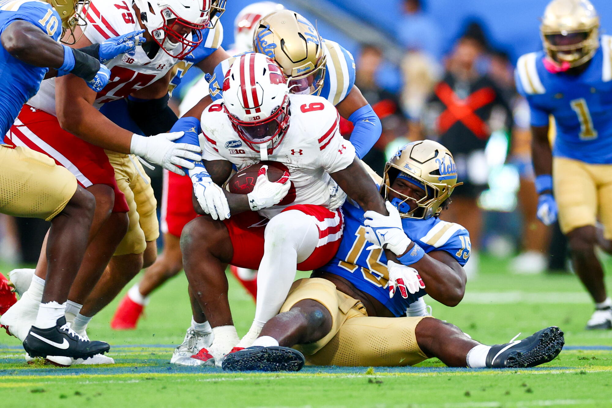 Wisconsin running back Darrion Dupree is tackled by UCLA defensive lineman Sahir West during the second quarter.