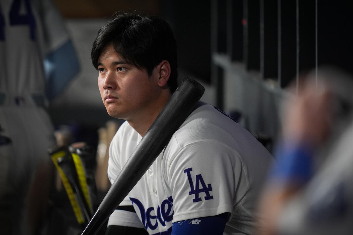 Los Angeles Dodgers designated hitter Shohei Ohtani watches from the dugout during the ninth inning.