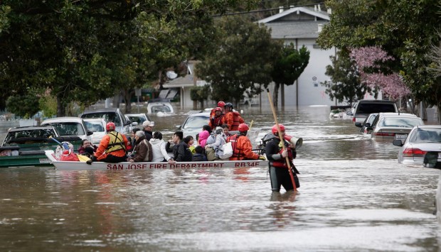 San Jose Fire Department rescuers evacuate the last residents from their homes along the flooded streets on Welch Ave and Needles Drive near Kelley Park in San Jose, Calif. on Tuesday, Feb. 21, 2017. (Josie Lepe/Bay Area News Group)