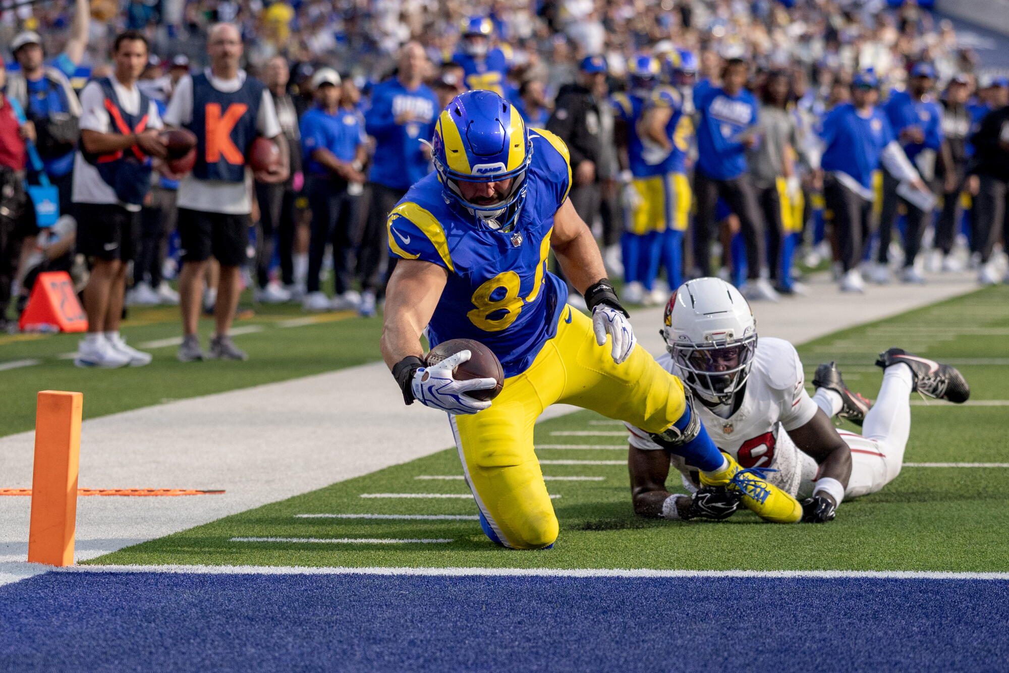 Rams tight end Colby Parkinson scores a touchdown in front of Cardinals safety Andrew Wingard at SoFi Stadium Sunday.