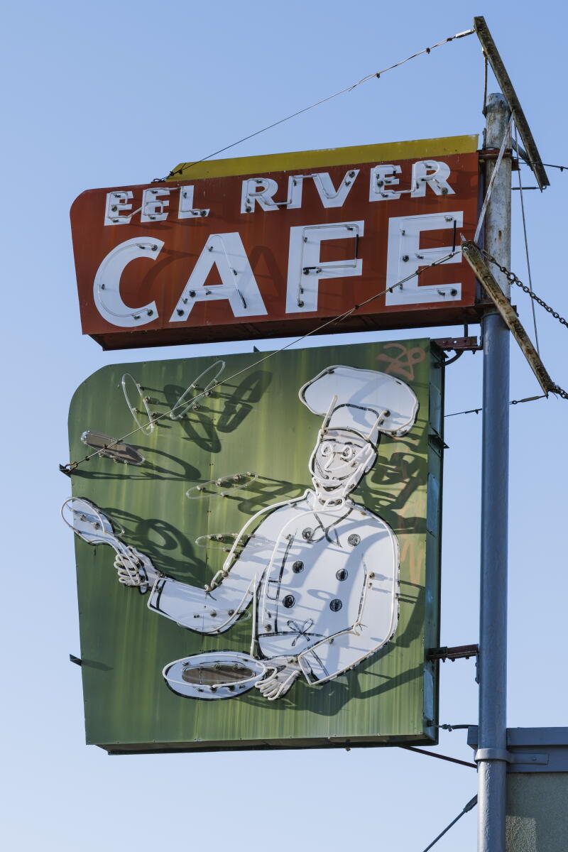 A cafe sign stands over Garberville, California
