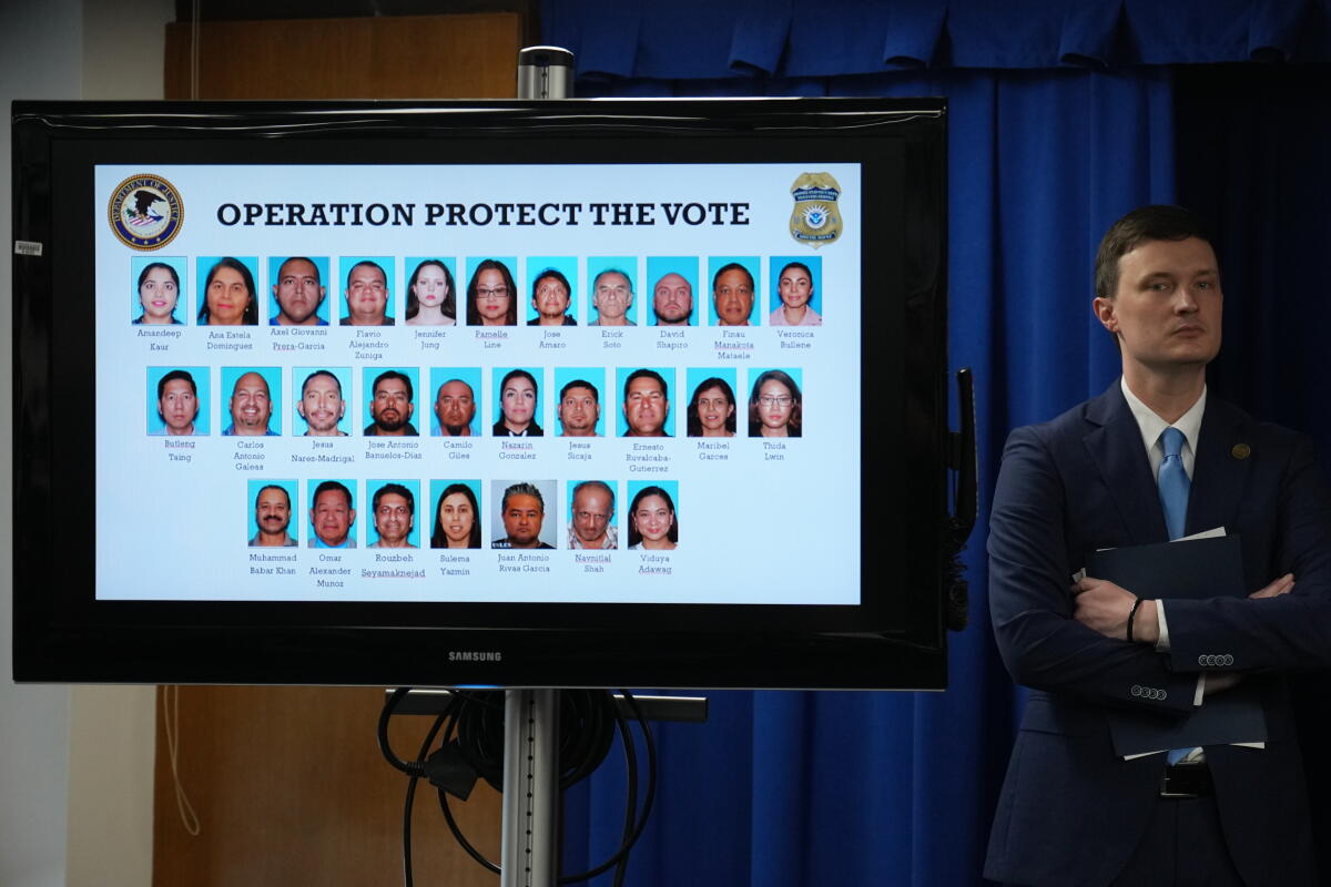 A display showing photos of people charged with illegally registering to vote.
