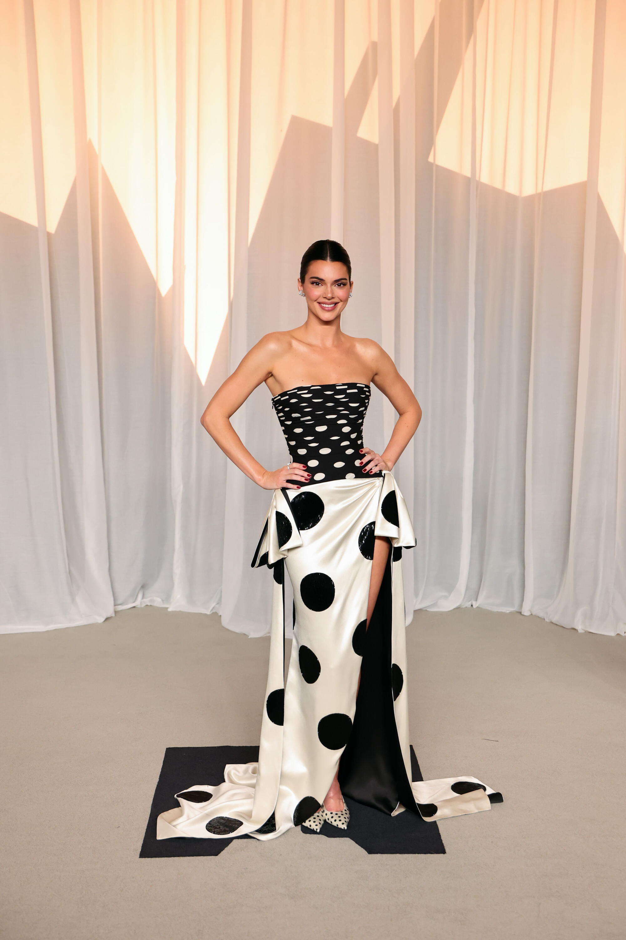 Kendall Jenner poses in a black-and-white polka-dotted gown. 