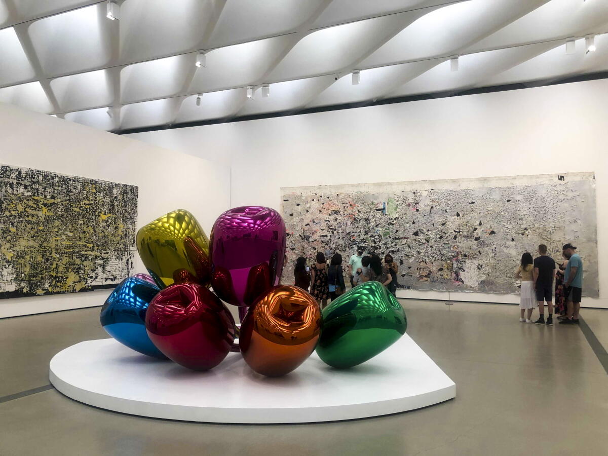 A massive glass sculpture of colorful tulips on display in a museum. 