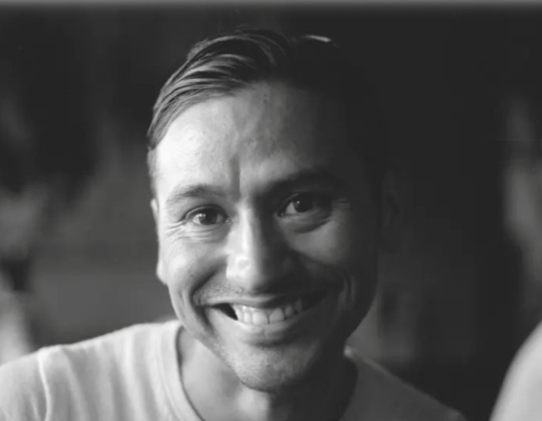 Black and white portrait of a smiling person.
