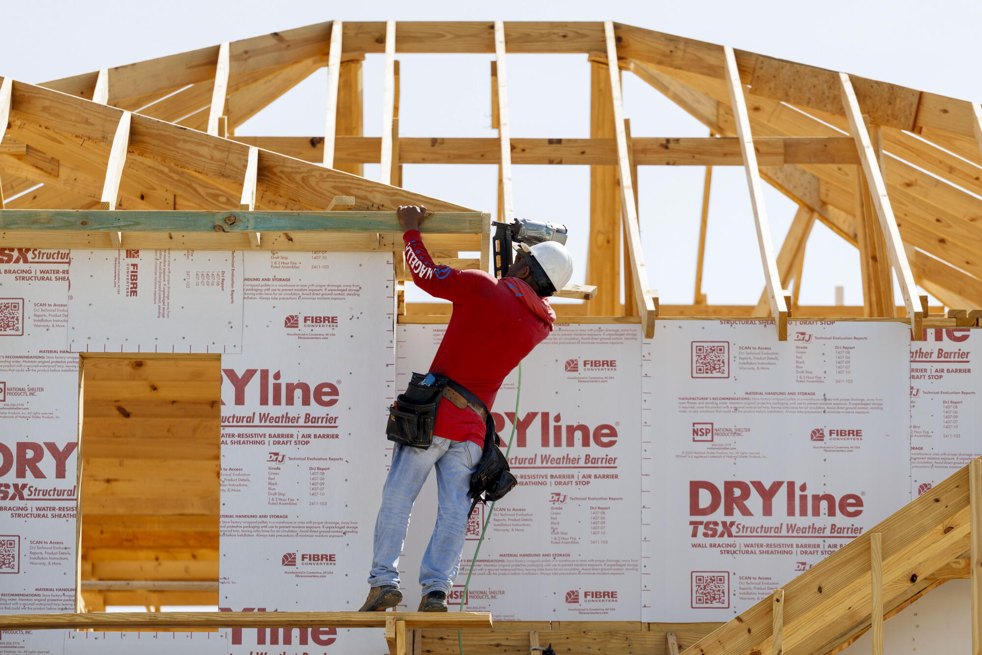 A construction worker on a new home under construction