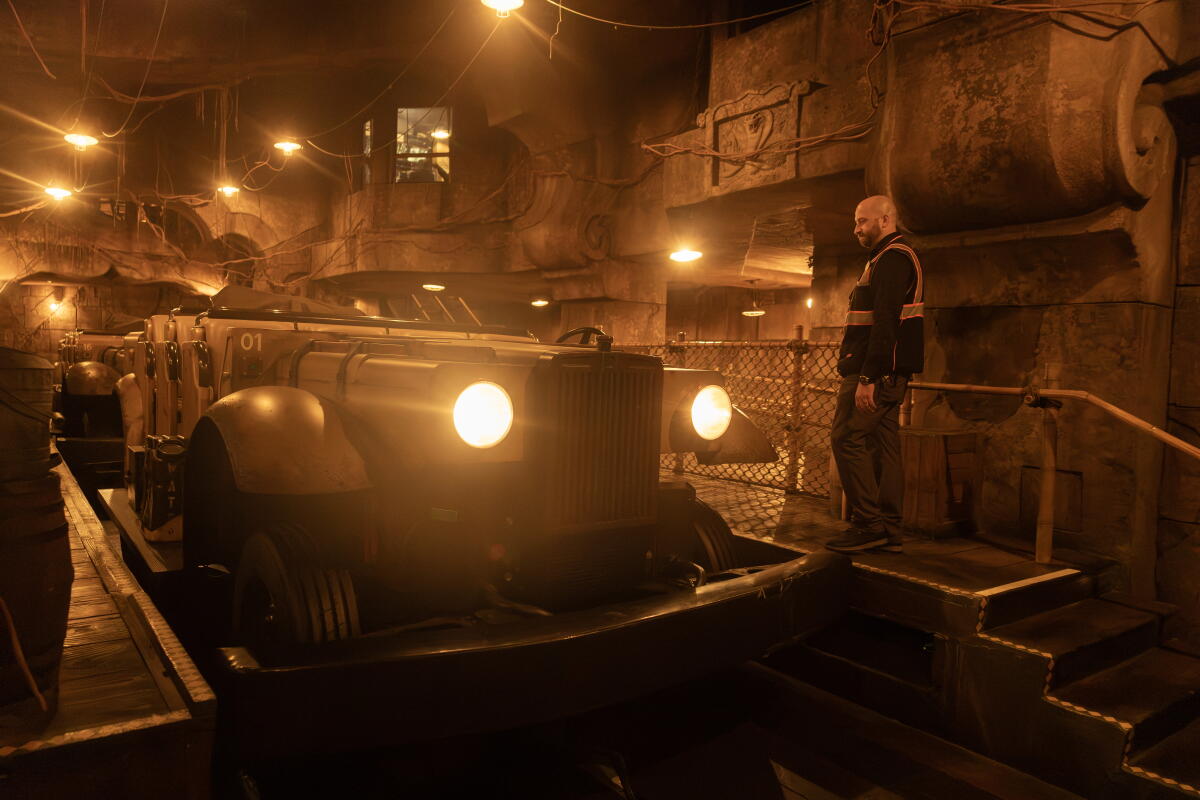 A man in front of a car.