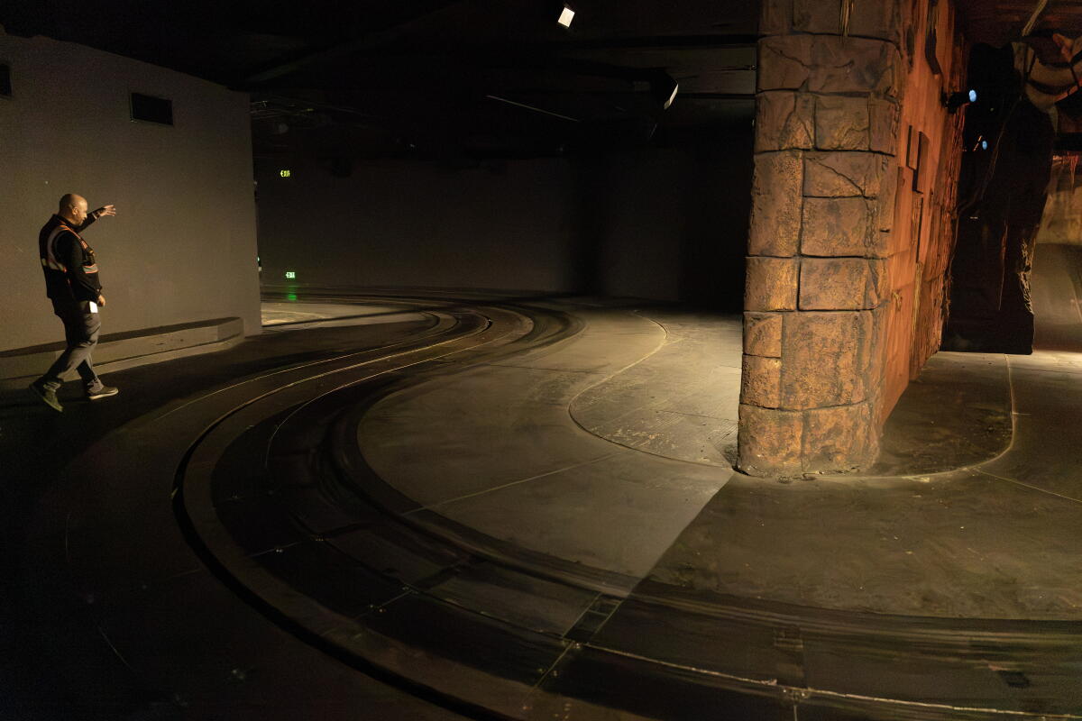 A man walks along tracks.