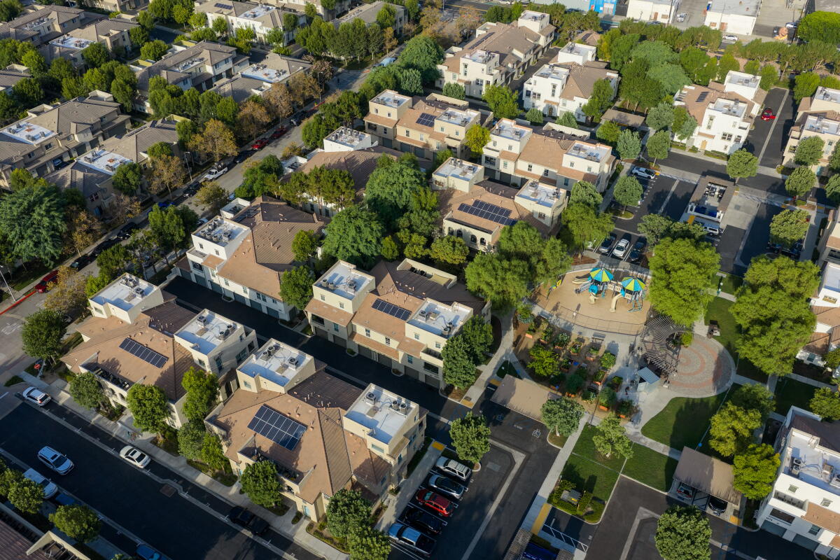 A drone view of blocks of two-, or three-story buildings.