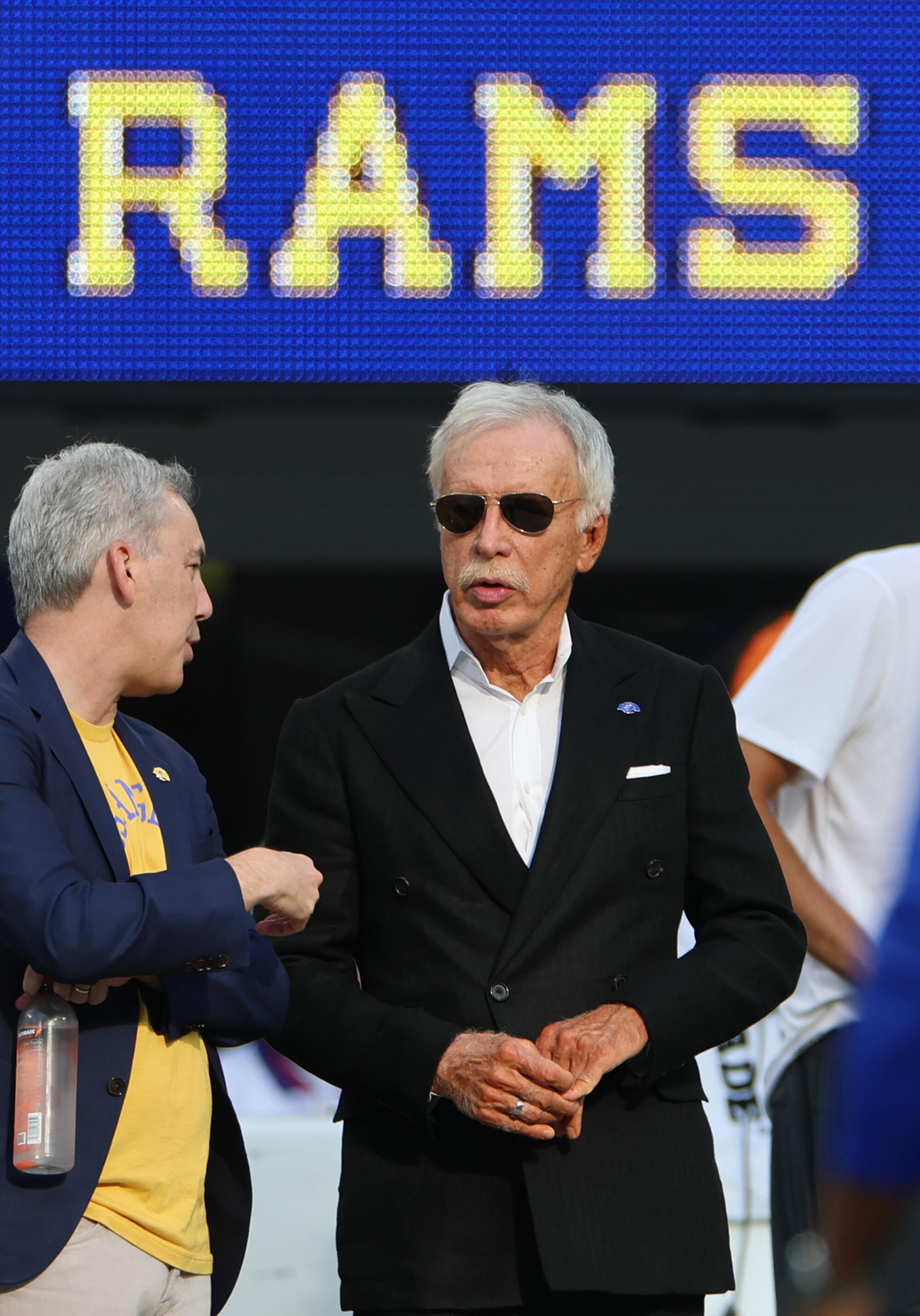 Rams owner Stan Kroenke, right, talks to Rams president Kevin Demoff before a Rams vs. New York Giants game.