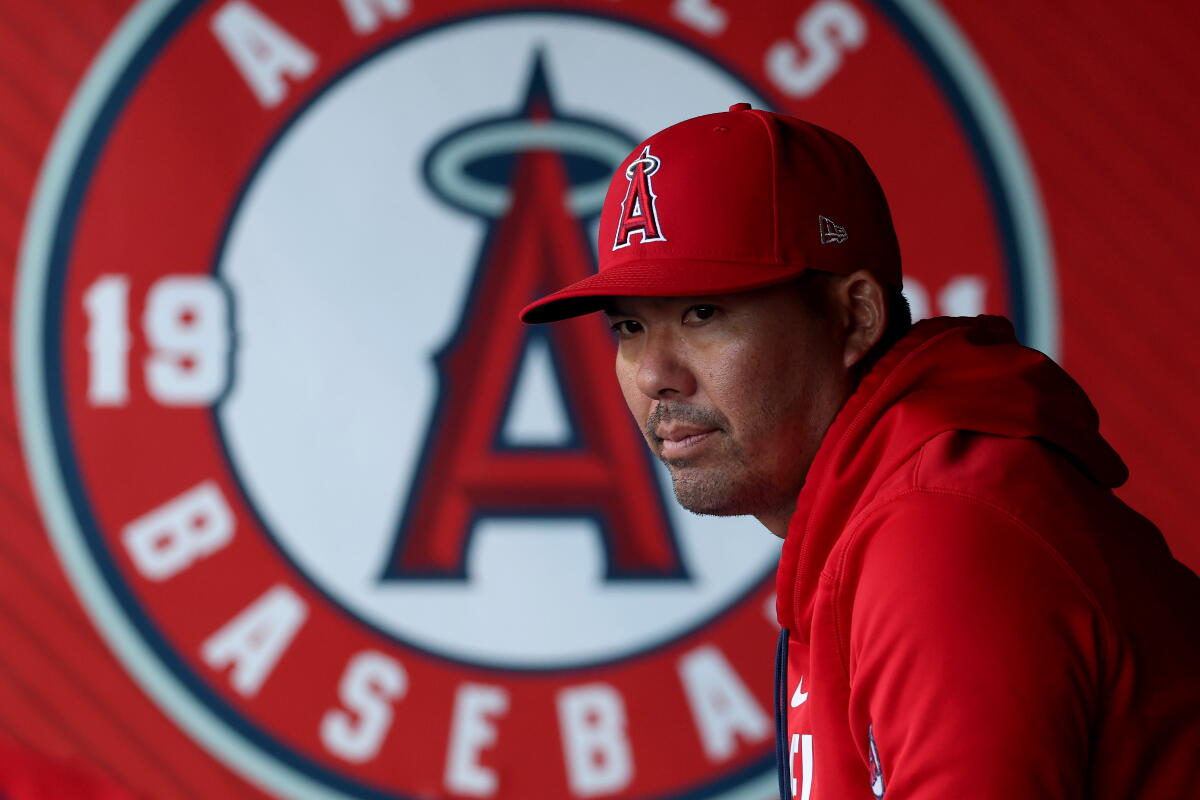 Angels manager Kurt Suzuki looks across the field during a game.