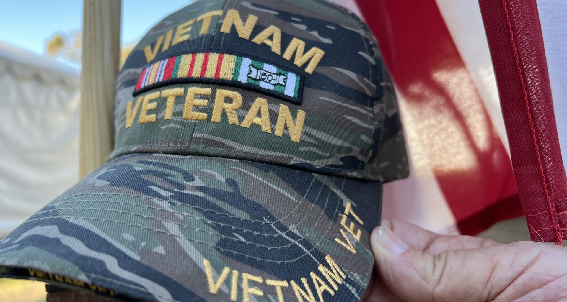 Vietnam veteran hat in front of American flag