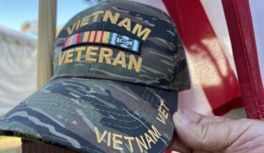 Vietnam veteran hat in front of American flag