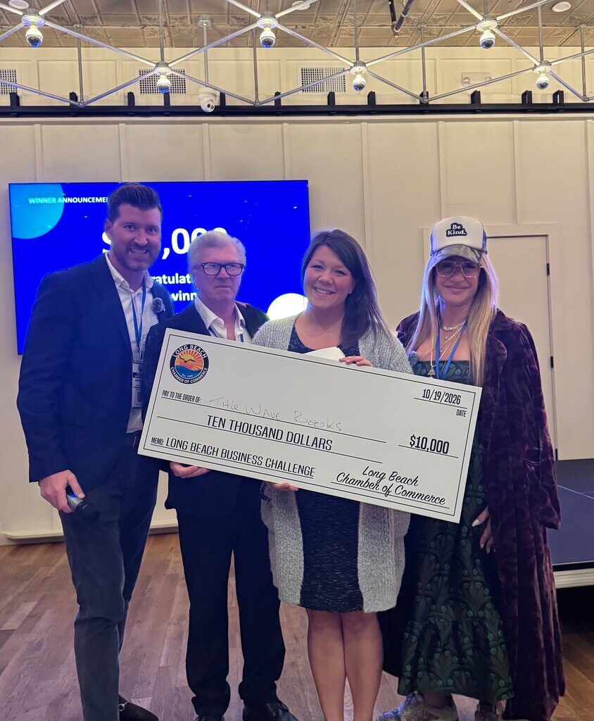 Long Beach Chamber of Commerce vice chairperson John Boland, left, treasurer Ian Danby, and chairperson Leah Tozer-Rosensweig, far right, presented Kate Scotti with a $10,000 grant at Bright Eye Beer Co. as part of the chamber&rsquo;s business challenge.