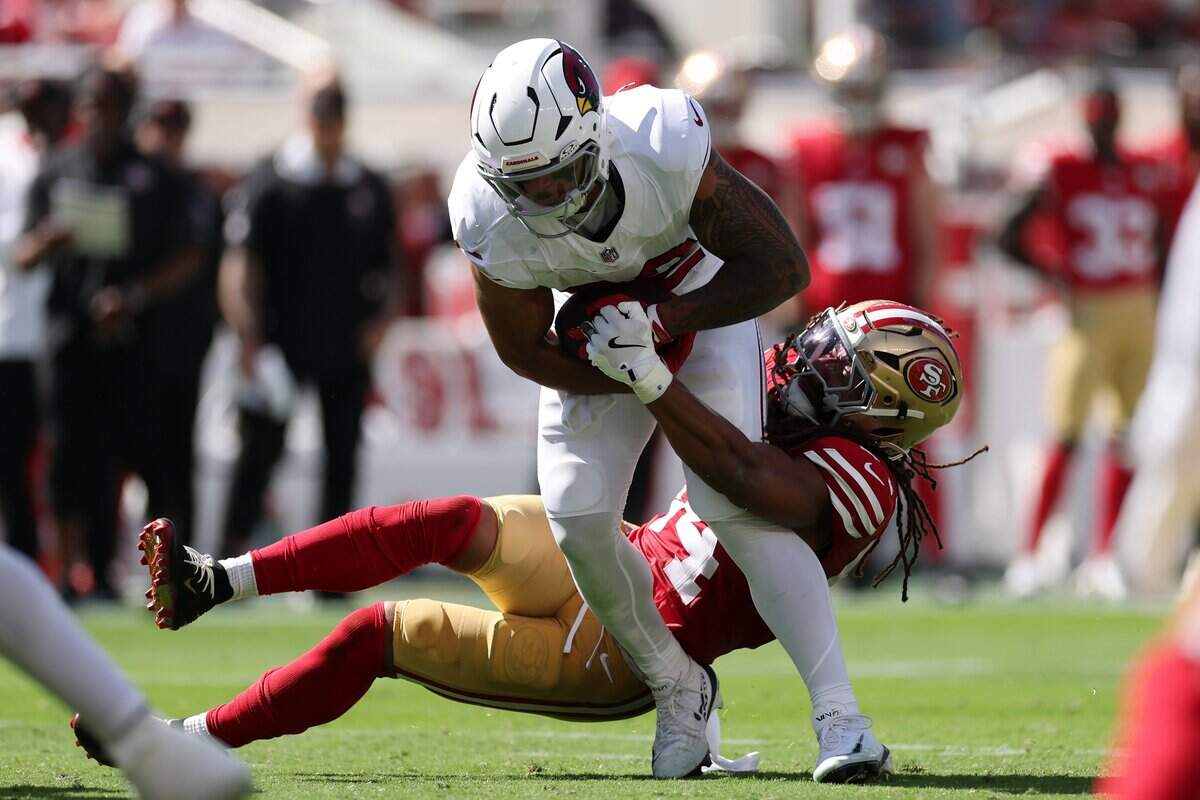 Tyler Allgeier of the Arizona Cardinals is tackled by Fred Warner of the San Francisco 49ers during the second quarter Sunday, Sept. 27, at Levi's Stadium in Santa Clara.