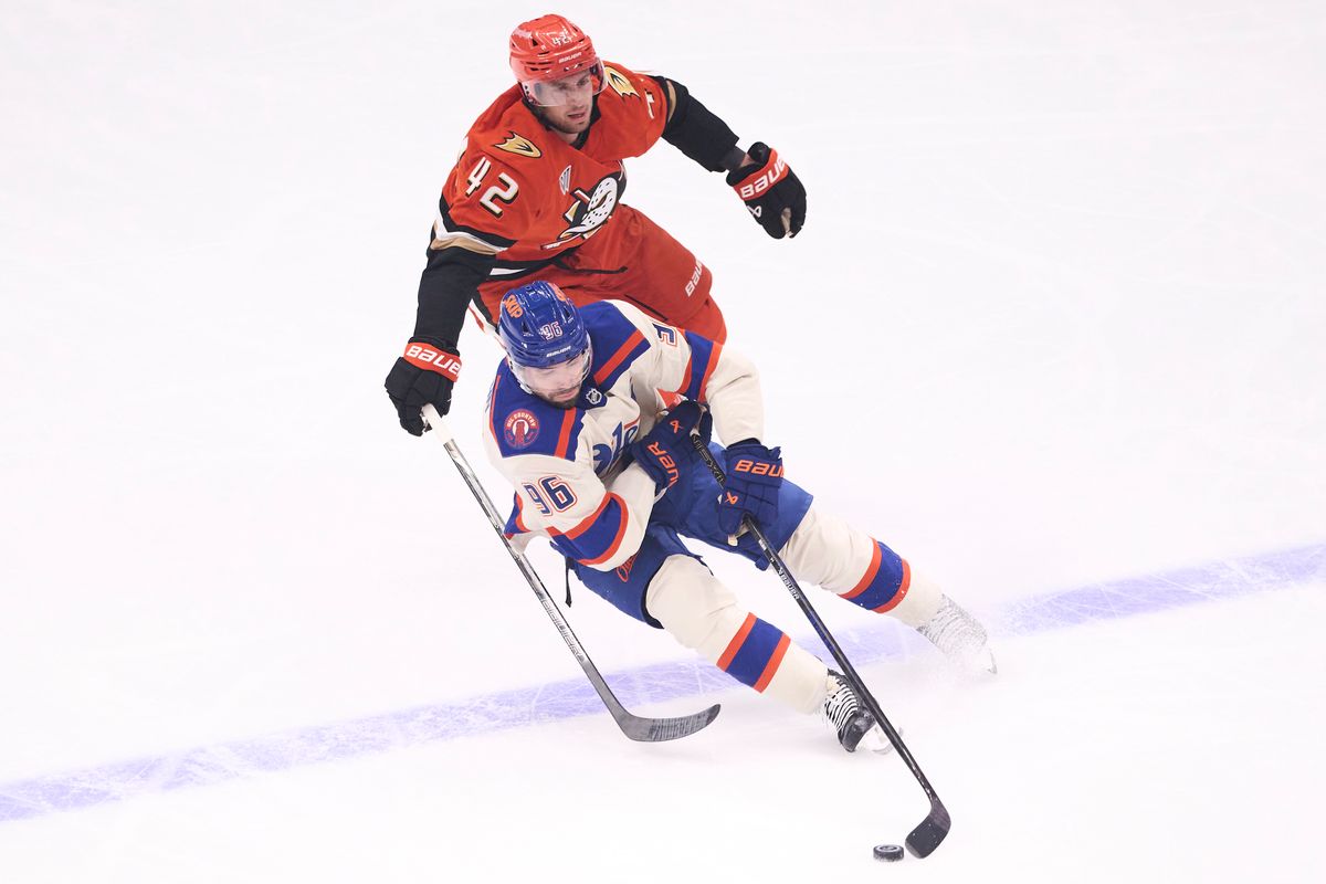 The Anaheim Ducks center Tim Washe #42 reaches for the puck against Edmonton Oilers center Jason Dickinson #16 during an NHL game against The Edmonton Oilers on October 7th, 2026 Honda Center in Anaheim, California.