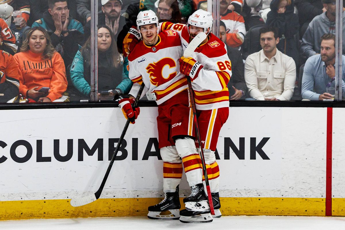 Yegor Sharangovich #17 of the Calgary Flames celebrates with Joel Farabee #86 of the Calgary Flames after scoring a goal during an NHL game against the Anaheim Ducks on October 13, 2026 at Honda Center in Anaheim, California.