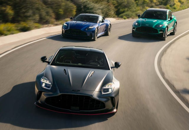 three sports cars driving on a winding road.