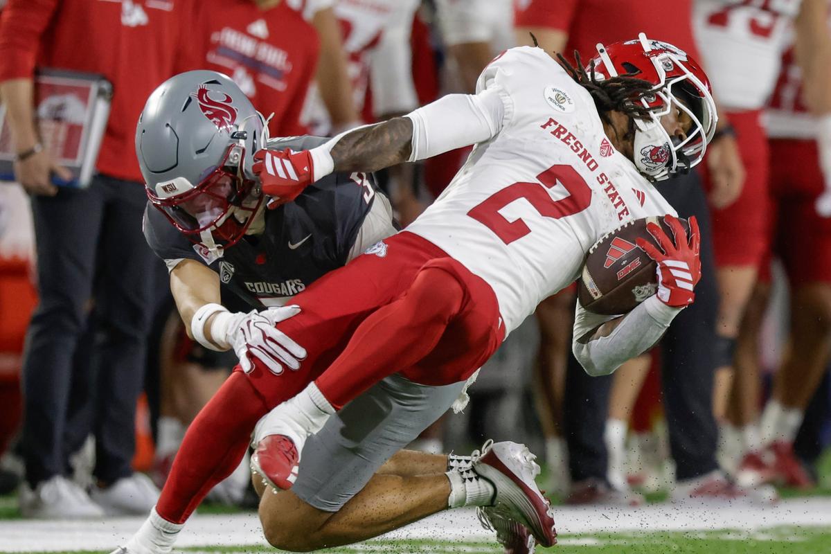 Washington State safety Jaylen Thomas, left, brings down Fresno State running back Rayshon Luke (2) in the first half on Saturday, Oct. 3, 2026, at Gesa Field in Pullman, Wash.  (Geoff Crimmins/For The Spokesman-Review)