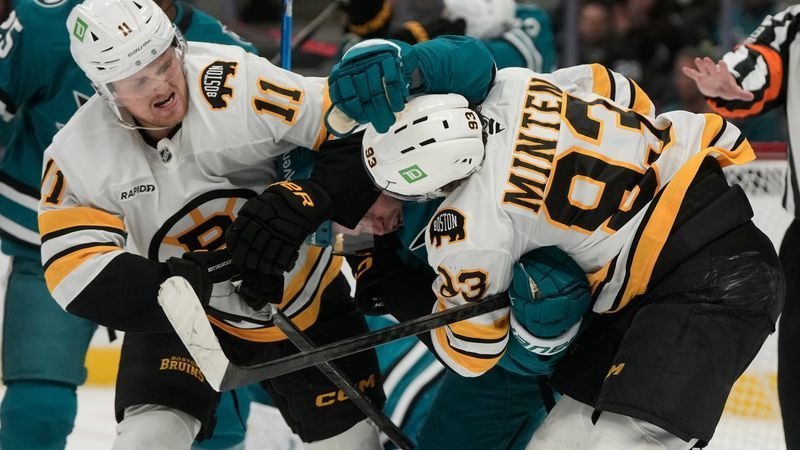 San Jose Sharks defenseman Jacob Trouba, middle, fights Boston Bruins center Casey Mittelstadt (11) and center Fraser Minten (93) during the second period of an NHL hockey game, Tuesday, Oct. 13, 2026, San Jose, Calif. (AP Photo/Jeff Chiu)
