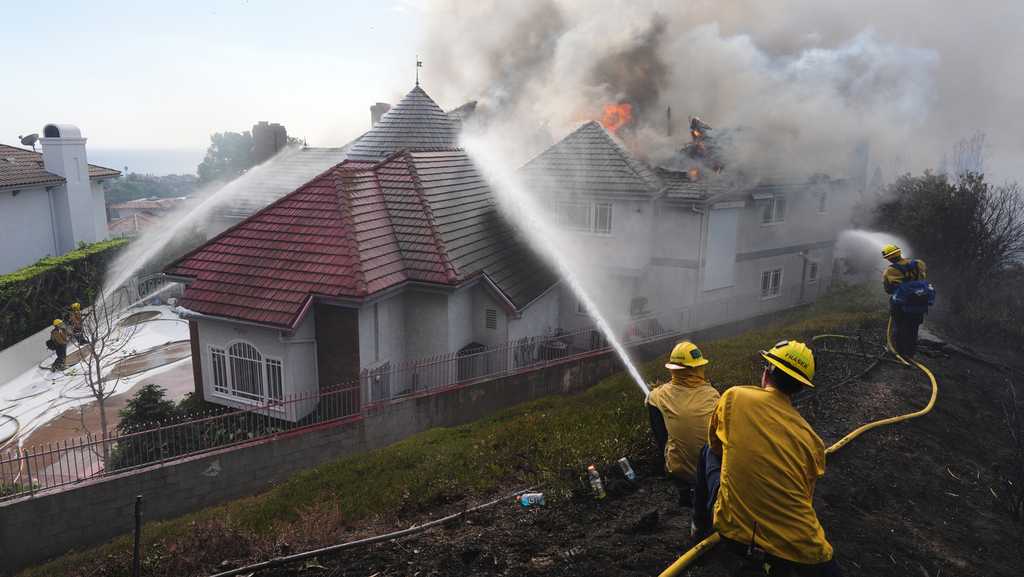 Coastal homes burn as hot winds fuel California fires