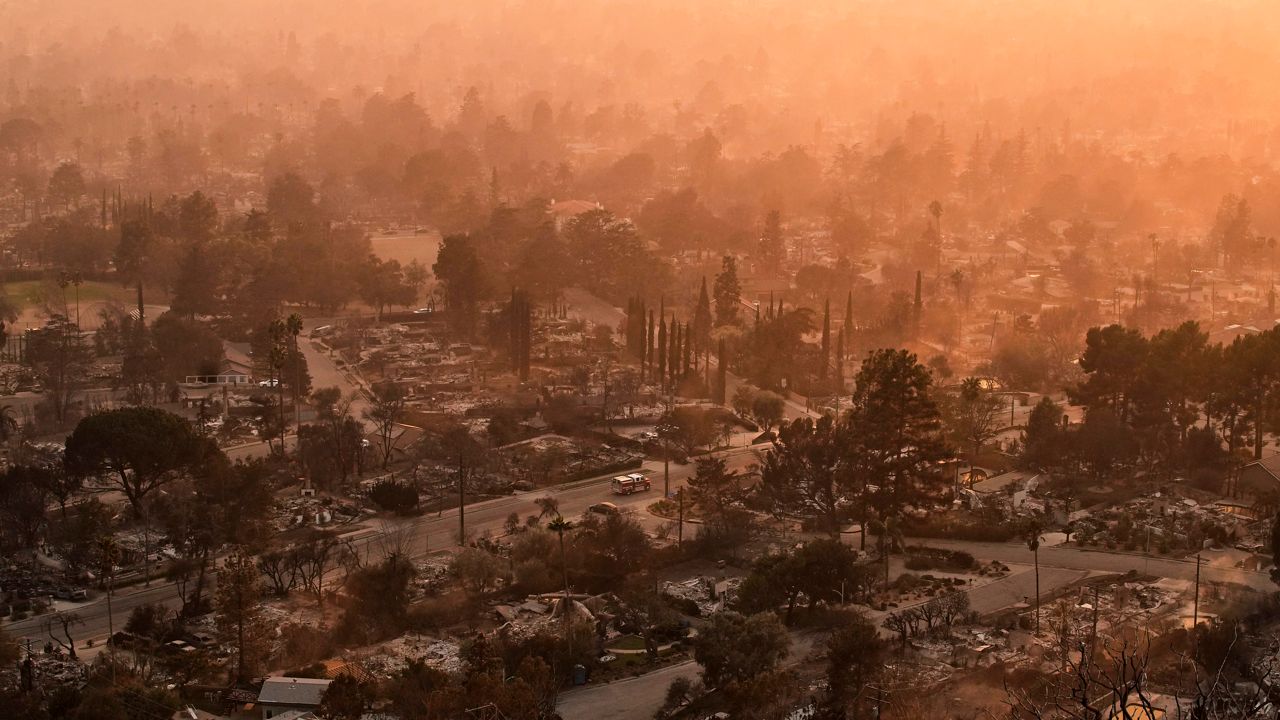 Smoke lingers over a neighborhood devastated by the Eaton Fire, Thursday, Jan. 9, 2025, in Altadena, Calif. (AP Photo/John Locher)