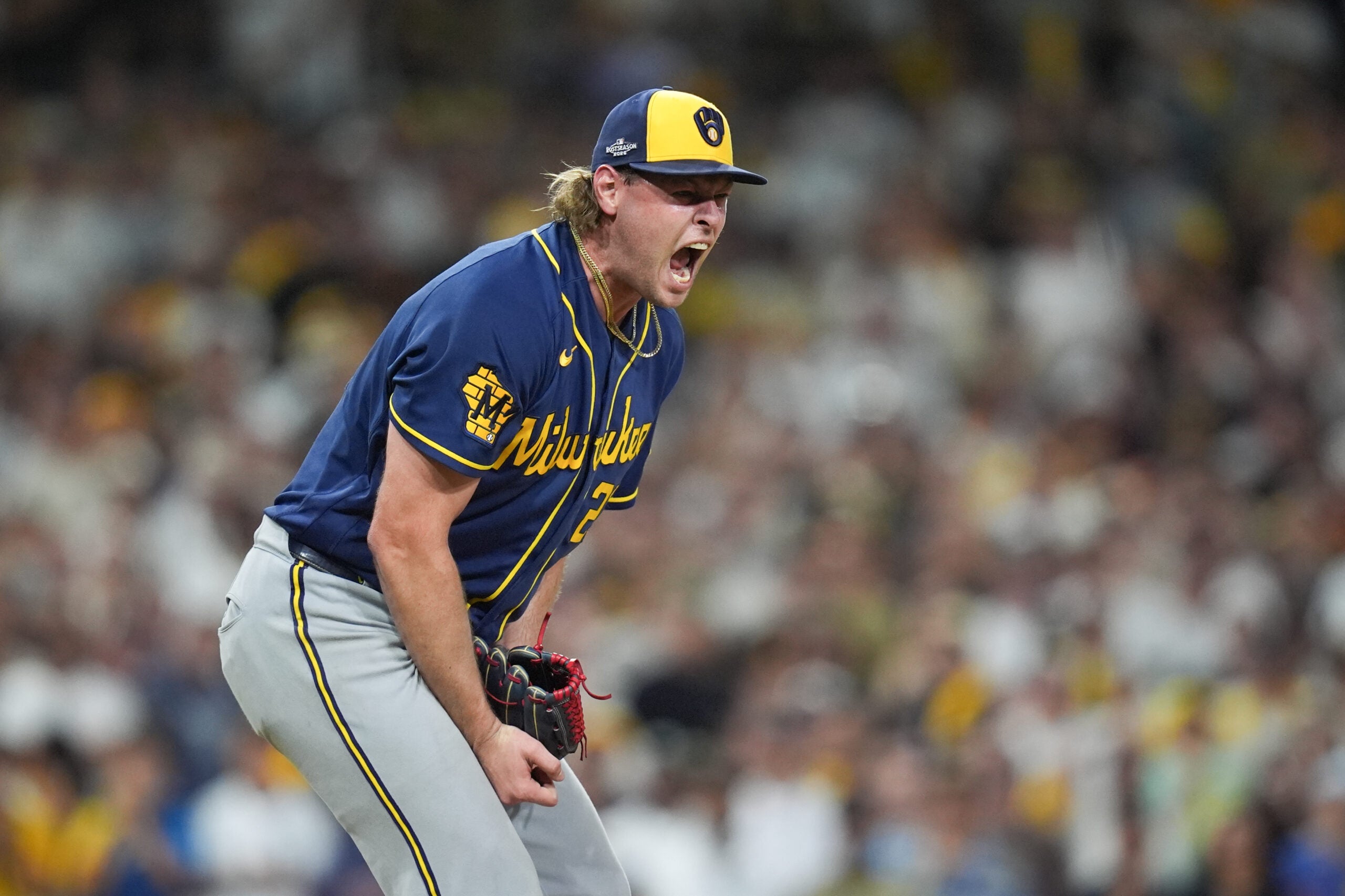 A Milwaukee Brewers pitcher yells while on the mound during a game.