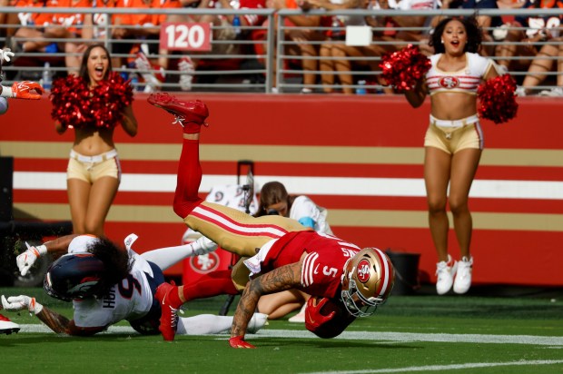 San Francisco 49ers' Mike Evans (5) is tackled at the end of a 17-yard catch against Denver Broncos' Talanoa Hufanga (9) in the fourth quarter at Levi's Stadium in Santa Clara, Calif., on Sunday, Oct. 4, 2026. (Nhat V. Meyer/Bay Area News Group)