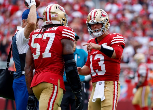 San Francisco 49ers starting quarterback Brock Purdy (13) celebrates his 56-yard touchdown throw to San Francisco 49ers' George Kittle (85) with San Francisco 49ers' Dre Greenlaw (57) against the Denver Broncos in the fourth quarter at Levi's Stadium in Santa Clara, Calif., on Sunday, Oct. 4, 2026. (Nhat V. Meyer/Bay Area News Group)