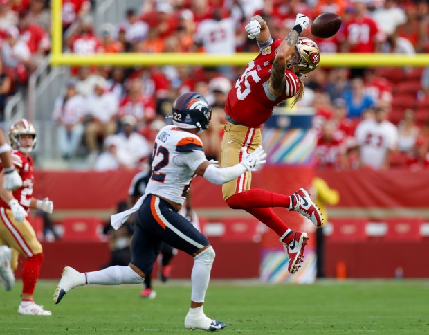 San Francisco 49ers' George Kittle (85) can't come down with a pass against Denver Broncos' Brandon Jones (22) in the third quarter at Levi's Stadium in Santa Clara, Calif., on Sunday, Oct. 4, 2026. (Nhat V. Meyer/Bay Area News Group)