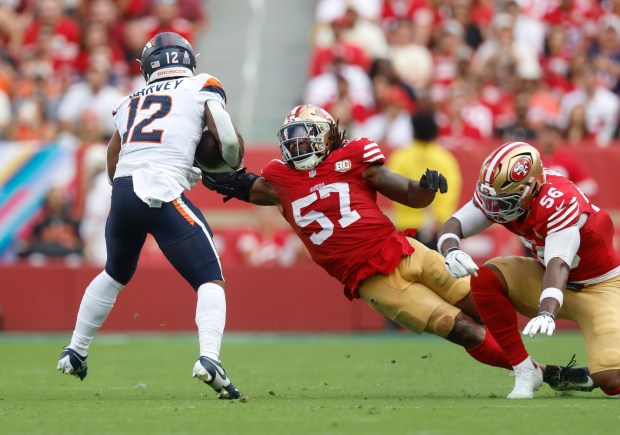 San Francisco 49ers' Dre Greenlaw (57) attempts to tackle Denver Broncos' RJ Harvey (12) in the third quarter at Levi's Stadium in Santa Clara, Calif., on Sunday, Oct. 4, 2026. (Nhat V. Meyer/Bay Area News Group)