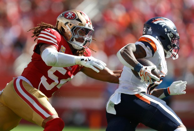 San Francisco 49ers' Fred Warner (54) tackles Denver Broncos' RJ Harvey (12) in the second quarter at Levi's Stadium in Santa Clara, Calif., on Sunday, Oct. 4, 2026. (Nhat V. Meyer/Bay Area News Group)