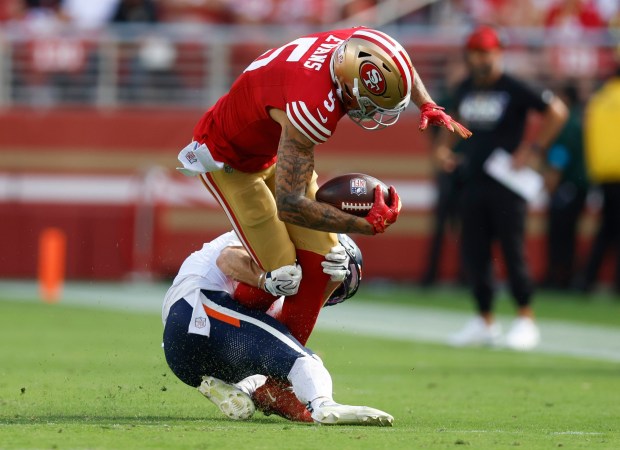 San Francisco 49ers' Mike Evans (5) is tackled after a catch by Denver Broncos' Riley Moss (21) in the second quarter at Levi's Stadium in Santa Clara, Calif., on Sunday, Oct. 4, 2026. (Nhat V. Meyer/Bay Area News Group)