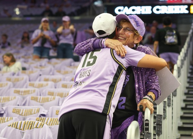 Cynthia Cheak, known as Bahalla Mama, hugs another fan before the Golden State Valkyries play against the Atlanta Dream during game 1 of the WNBA Finals at the Chase Center in San Francisco, Calif., on Saturday, Oct. 17, 2026. (Shae Hammond/Bay Area News Group)