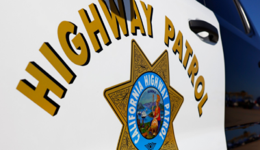 "Highway Patrol" is written above a gold seven-pointed star badge that reads "California Highway Patrol" on a black and white vehicle door.