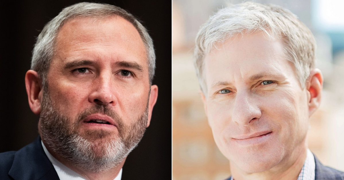 A man with short gray hair and beard wears a suit and tie, while another clean-shaven man with light hair smiles wearing a checked shirt and blazer.