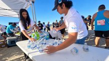 Volunteers provided a steady flow of cold water to runners during the 5K race, Saturday, October 3, 2026.