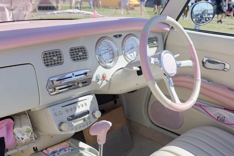 The interior of a pink car