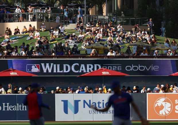 Fans find seats on a grassy hill while the Cubs warm up to face the Padres in Game 2 of their wild-card series on Sept. 30, 2026, in San Diego. (Brian Cassella/Chicago Tribune)