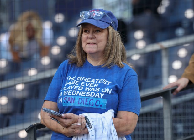 Lori Drake, a Cubs fan originally from Chicago Heights, updates her World Series shirt to replace Cleveland with San Diego before Game 2 of their wild-card series on Sept. 30, 2026, in San Diego. (Brian Cassella/Chicago Tribune)