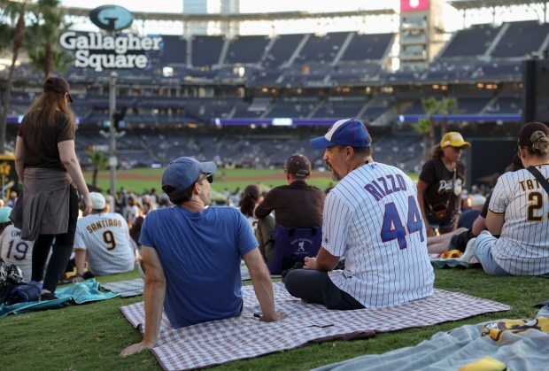 Cubs fans find a spot on the grass overlooking the outfield before facing the Padres in Game 2 of their wild-card series on Sept. 30, 2026, in San Diego. (Brian Cassella/Chicago Tribune)