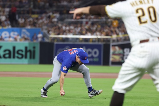 Cubs right fielder Matt Shaw fields a ground ball but cannot retire Padres center fielder Jackson Merrill during the second inning against the Padres in Game 2 of their wild-card series on Sept. 30 2026, in San Diego. (Brian Cassella/Chicago Tribune)