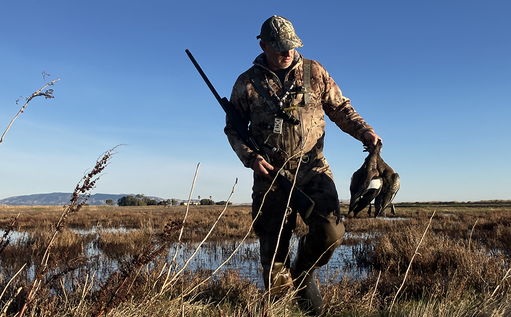 Hunter carrying ducks